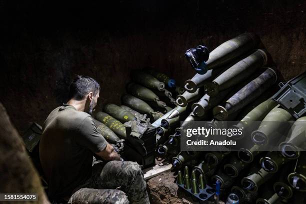 Ukrainian soldier prepares 155mm artillery shells in his fighting position as Ukrainian Army conduct operation to target trenches of Russian forces...