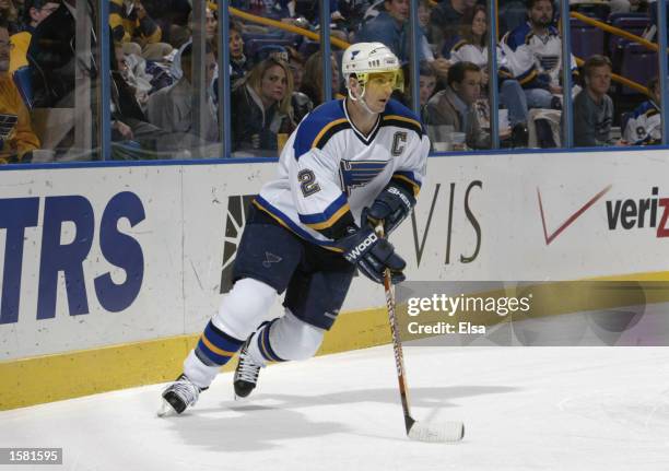 Defenseman Al MacInnis of the St. Louis Blues plays the puck behind the net against the Carolina Hurricanes during their NHL game on October 15, 2002...