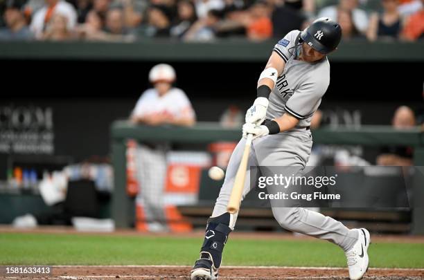 Jake Bauers of the New York Yankees hits a home run in the third inning against the Baltimore Orioles at Oriole Park at Camden Yards on July 30, 2023...