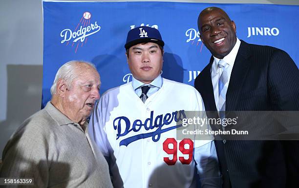 Hyun-Jin Ryu poses with Dodgers owner Ervin Magic Johnson and team executive Tommy Lasorda at a press conference introducing him following his...