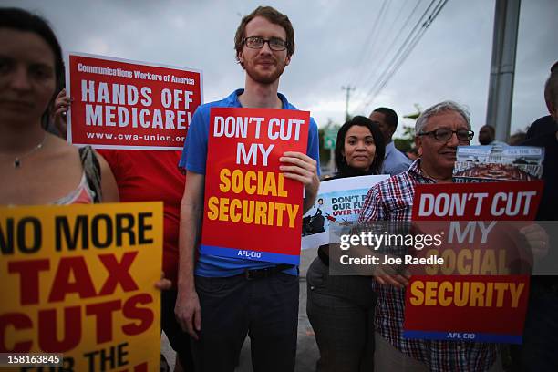 Glenn Rehn and other protesters rally together outside the office of U.S. Sen. Marco Rubio on December 10, 2012 in Doral, Florida. The protesters are...