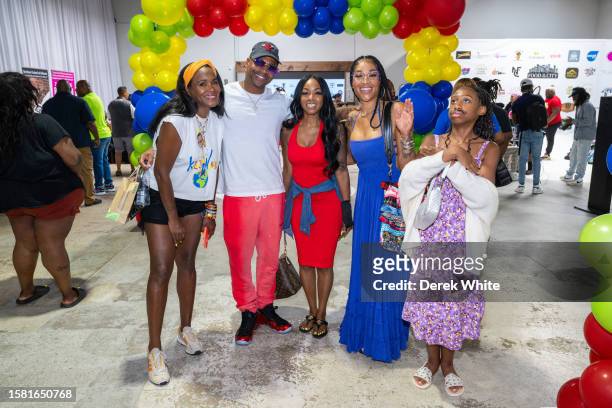 Tameka Foster, Stevie J, Jazzy McBee, Mimi Faust, and Eva Jordan attend Food In The City Back To School Drive at Midtown Collective Studio on July...