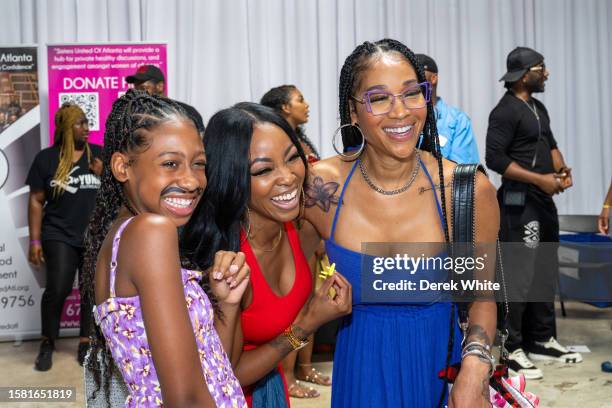 Eva Jordan, Jazzy McBee, and Mimi Faust attend Food In The City Back To School Drive at Midtown Collective Studio on July 30, 2023 in Atlanta,...