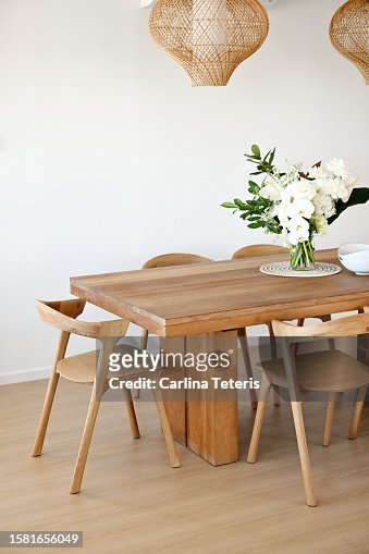 beautiful home dining table with vase of flowers