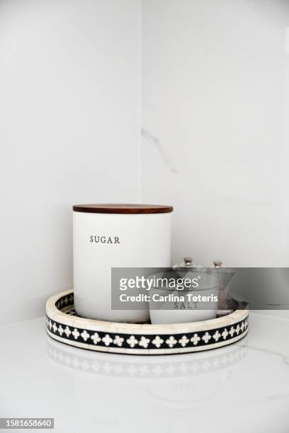 sugar and salt canisters on a marble counter - sugar jar stock pictures, royalty-free photos & images