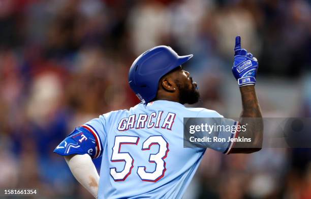 Adolis Garcia of the Texas Rangers celebrate after hitting a solo home run against the Miami Marlins during the eighth inning at Globe Life Field on...