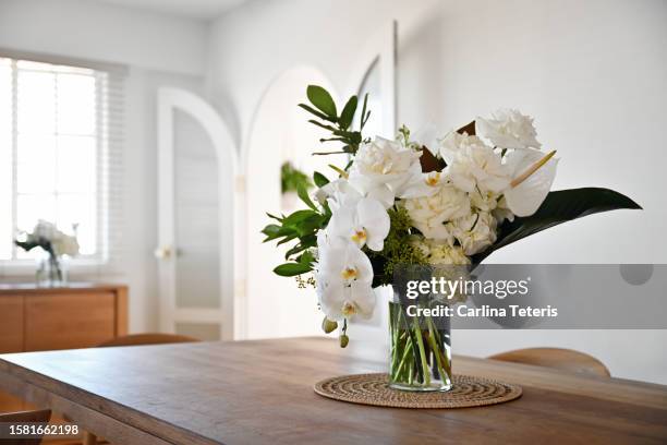 beautiful home dining table with vase of flowers - orchids of asia stock pictures, royalty-free photos & images