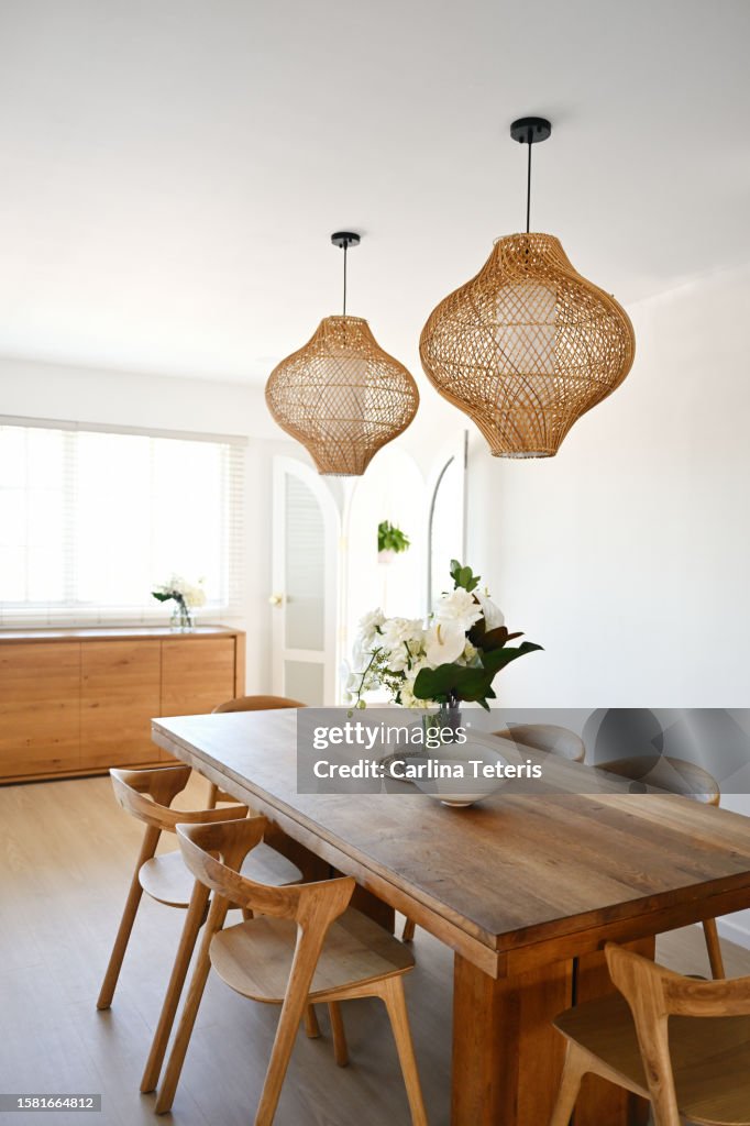 Beautiful home dining table with vase of flowers