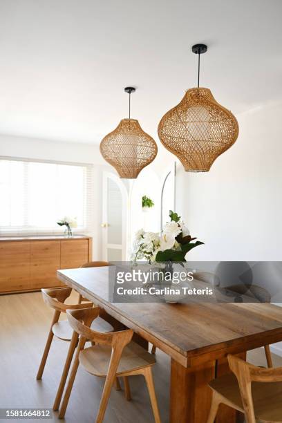beautiful home dining table with vase of flowers - pendant light - fotografias e filmes do acervo