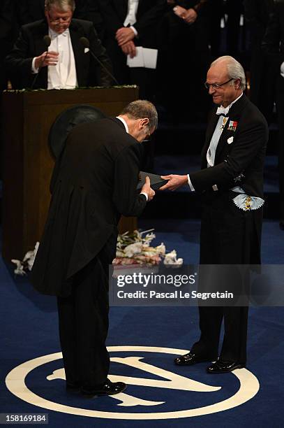 Nobel Prize in Physics laureate Professor Serge Haroche of France receives his Nobel Prize from King Carl XVI Gustaf of Sweden during the Nobel Prize...