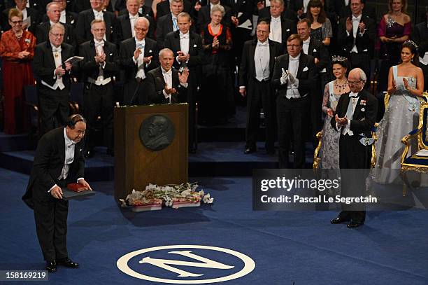 Nobel Prize in Literature laureate, author Mo Yan of China acknowledges applause after he received his Nobel Prize from King Carl XVI Gustaf of...