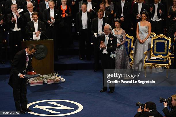 Nobel Prize in Medicine laureate Professor Shinya Yamanaka of Japan reacts after he received his Nobel Prize from King Carl XVI Gustaf of Sweden...