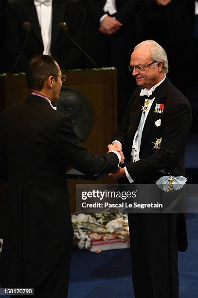 Nobel Prize in Medicine laureate Professor Shinya Yamanaka of Japan receives his Nobel Prize from King Carl XVI Gustaf of Sweden during the Nobel...