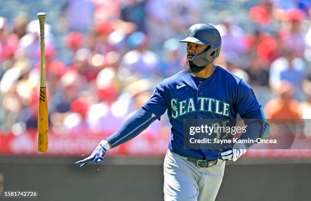 Teoscar Hernandez of the Seattle Mariners flips his bat after hitting a solo home run in the seventh inning against the Los Angeles Angels at Angel...