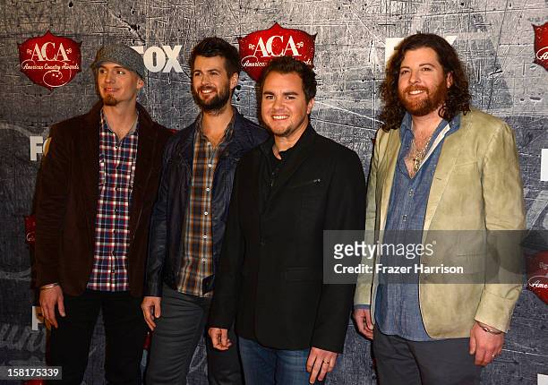 Bassist Jon Jones, drummer Chris Thompson, frontman Mike Eli and guitarist James Young of the Eli Young Band arrive at the 2012 American Country...