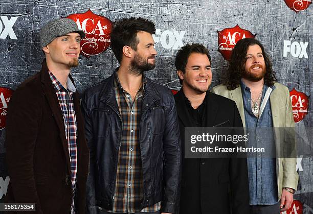 Bassist Jon Jones, drummer Chris Thompson, frontman Mike Eli and guitarist James Young of the Eli Young Band arrive at the 2012 American Country...