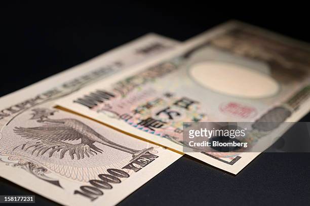 Japanese ten-thousand yen banknotes are arranged for a photograph in Kawasaki, Kanagawa Prefecture, Japan, on Monday, Dec. 10, 2012. The yen is...
