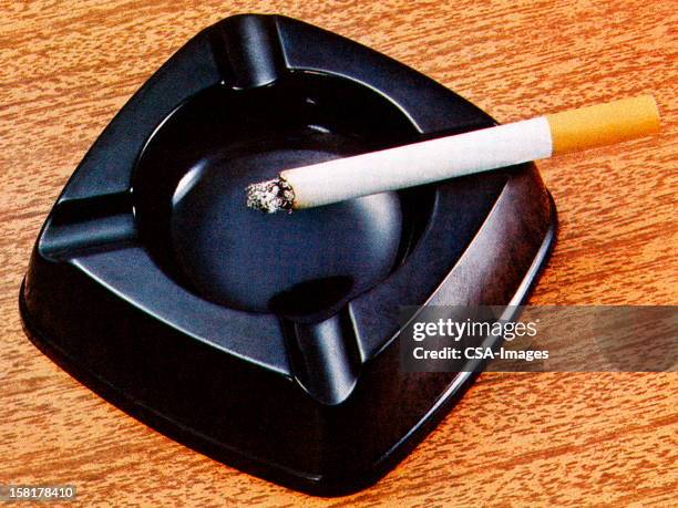 cigarette in ashtray - ashtray stock illustrations