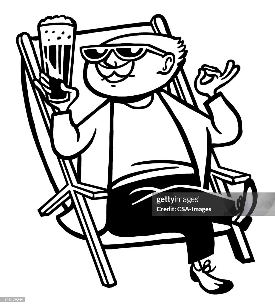 Man Drinking Cocktail Sitting in Chair