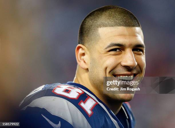 Aaron Hernandez of the New England Patriots smiles from the sidelines in the fourth quarter during a game against the Houston Texans at Gillette...