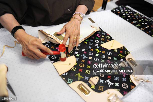 File picture taken on May 27, 2010 shows an employee of the French handbag compagny Louis Vuitton, part of world's largest luxury group LVMH, working...