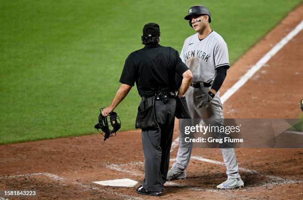 Anthony Rizzo of the New York Yankees argues with home plateumpire Phil Cuzzi after being called out on strikes in the fifth inning against the...