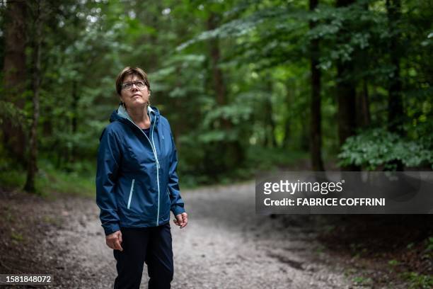 Swiss paper cutting artist Marianne Dubuis looks on in a forest near Chateau d'Oex, in the Prealps in western Switzerland on July 25, 2023. Marianne...