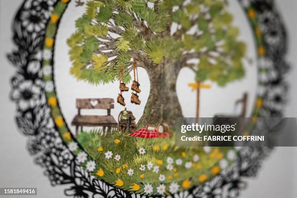 This photograph taken on July 25 shows a detail of a work by Swiss paper cutting artist Marianne Dubuis at the Swiss Centre of Paper Cut in Chateau...