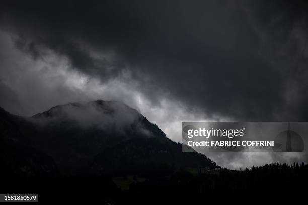 This photograph shows a view of heavy clouds during a rainfall near Chateau d'Oex, in the pre-Alps in western Switzerland, on July 25, 2023. Swiss...