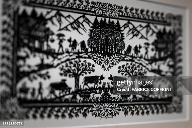 This photograph taken on July 25 shows a detail of a work by Swiss paper cutting artist Marianne Dubuis at the Swiss Centre of Paper Cut in Chateau...