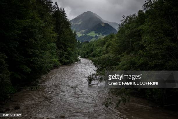 This photograph taken on shows a view of the Sarine river under heavy clouds near Chateau d'Oex, in the pre-Alps in western Switzerland, on July 25,...
