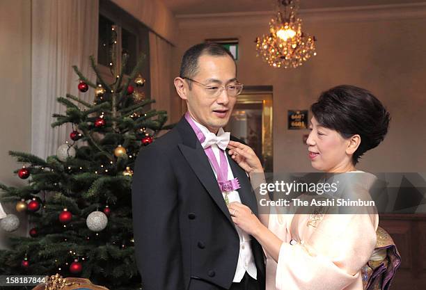 Chika Yamanaka , wife of Nobel Prize in Medicine laureate Shinya Yamanaka arranges her hudsband's bow tie ahead of the Nobel Prize Award Ceremony on...