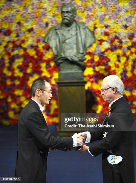 Nobel Prize in Medicine laureate Shinya Yamanaka receives the Nobel Prize from King Carl XVI Gustaf of Sweden during the Nobel Prize Award Ceremony...