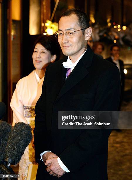 Nobel Prize in Medicine laureate Shinya Yamanaka speaks to the media reporters while his wife Chika listens after attending the Nobel Banquet at Town...