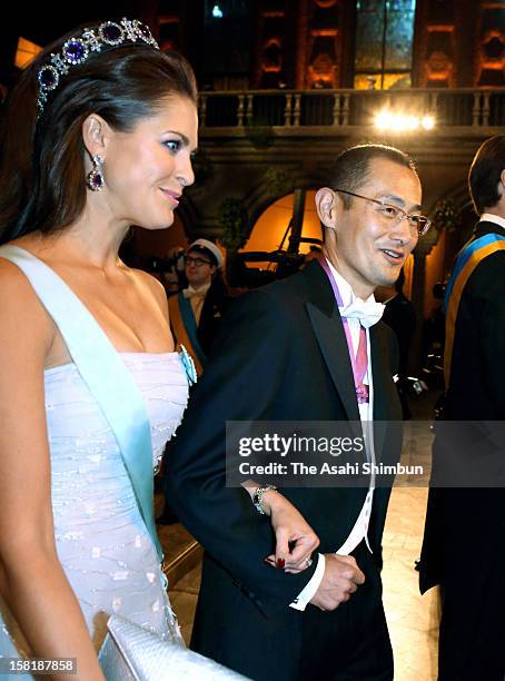 Princess Madeleine of Sweden is escorted by Nobel Prize in Medicine laureate Shinya Yamanaka to the Nobel Banquet at Town Hall on December 10, 2012...