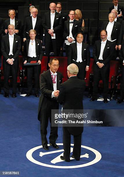 Nobel Prize in Medicine laureate Shinya Yamanaka receives the Nobel Prize from King Carl XVI Gustaf of Sweden during the Nobel Prize Award Ceremony...