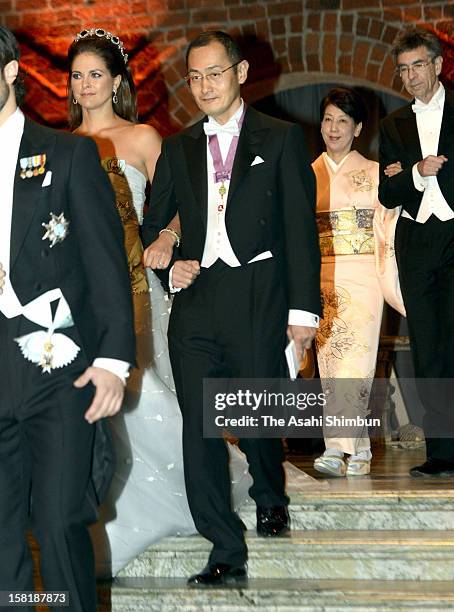 Princess Madeleine of Sweden is escorted by Nobel Prize in Medicine laureate Shinya Yamanaka while his wife Chika Yamanaka is escorted by Nobel Prize...