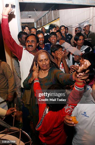 Grandmother of cricketer Parvinder Awana along with other family members celebrate his selection in the Indian cricket test team on 9th December,...