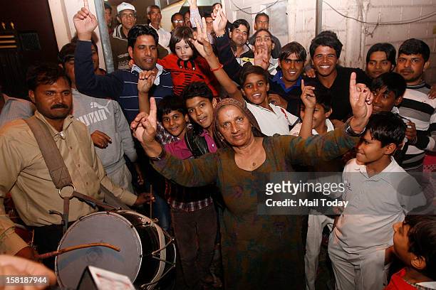 Grandmother of cricketer Parvinder Awana along with other family members celebrate his selection in the Indian cricket test team on 9th December,...