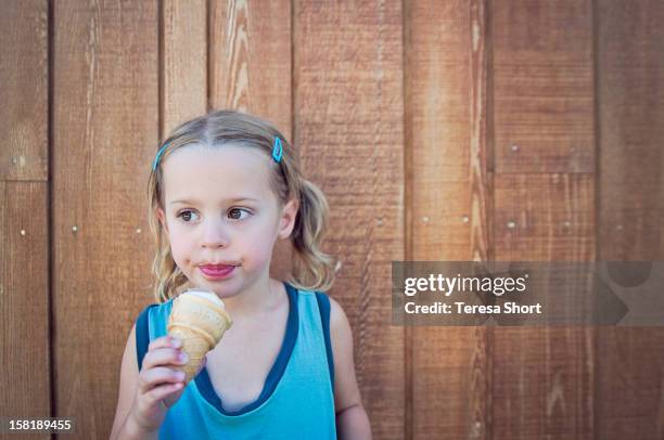girl eating ice cream cone - girl eating messy ice cream cone stock-fotos und bilder