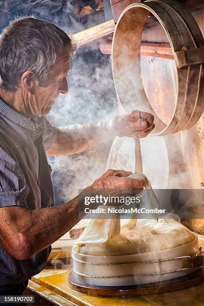 シニアスイスチーズ作りの農家 - swiss culture ストックフォトと画像