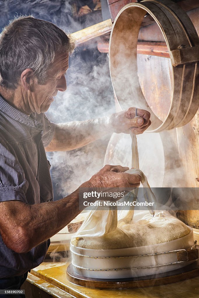 Senior Swiss Farmer making cheese