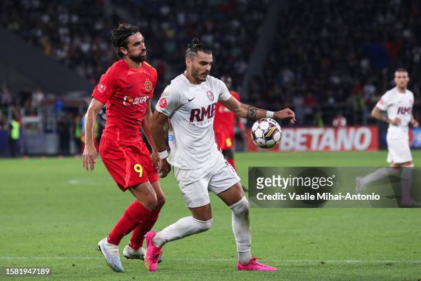Andrea Compagno of FCSB fights for the ball with Karlo Muhar of CFR Cluj during the SuperLiga Round 4 match between FCSB and CFR Cluj at Stadionul...
