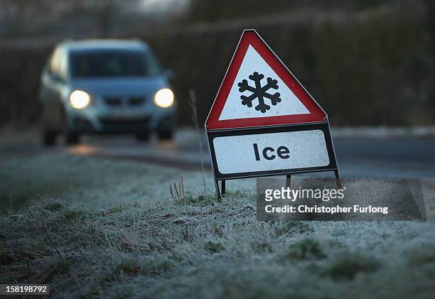 Warning triangle alerts drivers to an icy road on December 11, 2012 in Knutsford, England. Forecasters are warning that the UK could experience the...