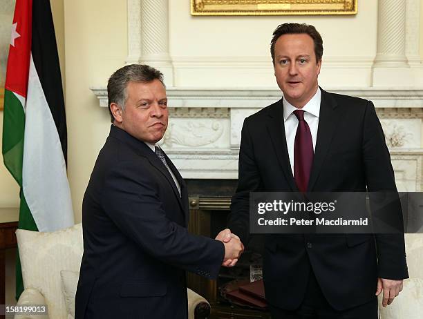 King Abdullah II of Jordan shakes hands with Prime Minister David Cameron inside 10 Downing Street on December 11, 2012 in London, England. King...