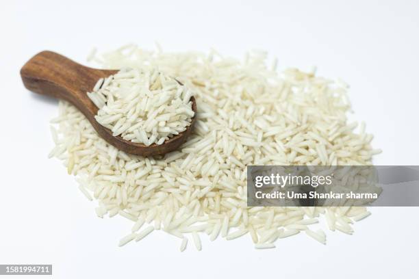 wooden full of uncooked white rice. - wooden spoon imagens e fotografias de stock