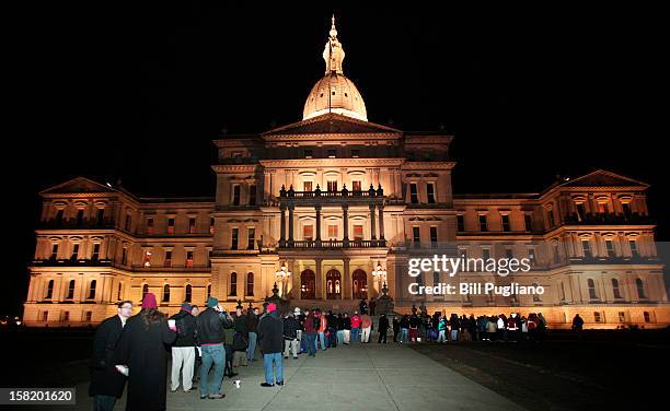 Union members from around the country line up early to enter the Michigan State Capitol where a vote on Right-to-Work legislation is scheduled to be...