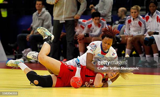 Allison Pineau of France battles for the ball with Helena Sterbova of Czech Republic during the Women's European Handball Championship 2012 Group I...