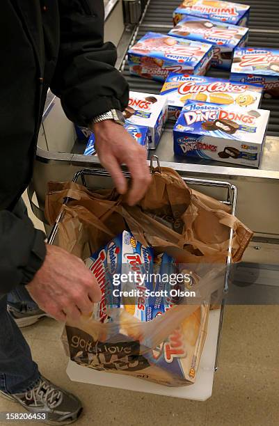 Customer bags his purchase of Hostess snacks at a Jewel-Osco grocery store on December 11, 2012 in Chicago, Illinois. The Jewel-Osco grocery store...