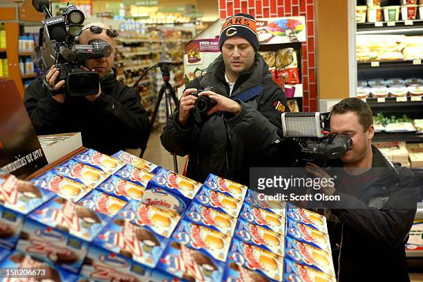 Members of the news media shoot a display of Hostess snacks at a Jewel-Osco grocery store on December 11, 2012 in Chicago, Illinois. The Jewel-Osco...